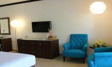 Elegant luxury bedroom at Cocoa Luxury Resort featuring a king-size bed, modern décor, and soft ambient lighting