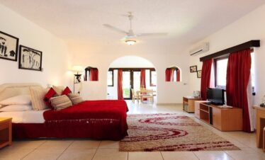 Elegant luxury bedroom at Cocoa Luxury Resort featuring a king-size bed, modern décor, and soft ambient lighting