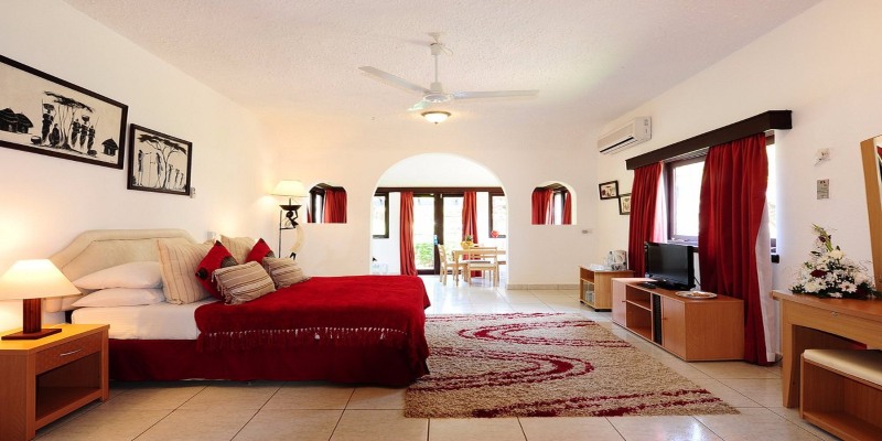 Elegant luxury bedroom at Cocoa Luxury Resort featuring a king-size bed, modern décor, and soft ambient lighting